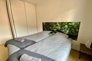 a bed sitting in a room with a window at Les Naïades I52 - 2 bedrooms for 5 people ! in Avène