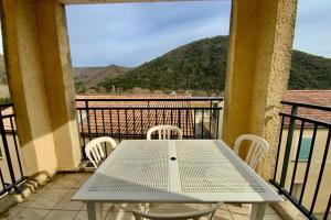 a table and chairs on a balcony with a view at Les Naïades I52 - 2 bedrooms for 5 people ! in Avène +7 photos
