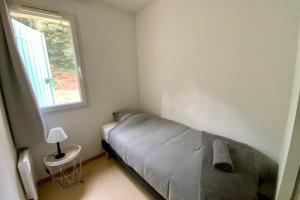a small bedroom with a bed and a window at Les Naïades I53 - 2 bedrooms for 5 people ! in Avène +9 photos