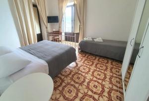 A bed or beds in a room at Il MOLO Camere per vacanze Még 28 kép