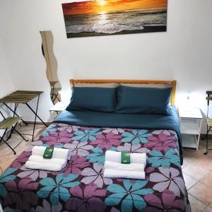 a bedroom with a bed with a colorful bedspread at Casa Soprani - Relax Marchigiano in Castelfidardo