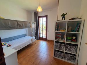 a room with a bunk bed and a book shelf at COSTA BRAVA SUITES Casa El Turó de Sagaró in S'Agaro
