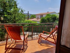 two rocking chairs sitting on a balcony at COSTA BRAVA SUITES Casa El Turó de Sagaró in S'Agaro