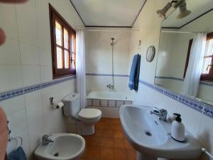 a bathroom with a sink and a toilet and a mirror at COSTA BRAVA SUITES Casa El Turó de Sagaró in S'Agaro +14 photos