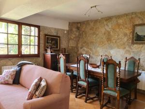 a living room with a table and chairs and a couch at COSTA BRAVA SUITES Casa El Turó de Sagaró in S'Agaro