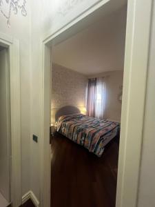 a bedroom with a bed and a door leading into a room at Scalette Pellicciai in Verona