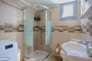 a bathroom with a shower and a toilet and a sink at Ocean Breeze Kassiopi in Kassiopi +13 photos