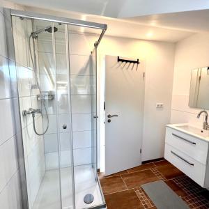 a bathroom with a shower and a sink at Ferienwohnungen Auf der Höhe in Engelsbrand