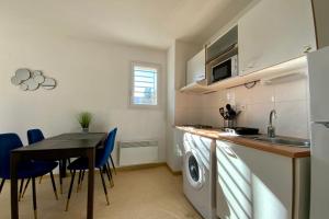 a kitchen with a table and a dining room at Les Naïades C08 - 2 bedrooms for 5 people ! in Avène