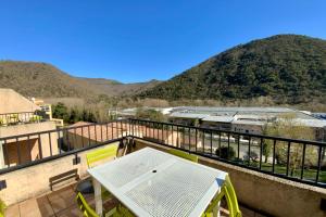 a balcony with a table and a view of mountains at Les Naïades C08 - 2 bedrooms for 5 people ! in Avène +5 photos