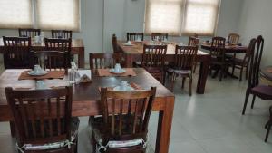a dining room with wooden tables and chairs at Pousada Bárbara Heliodora in Tiradentes