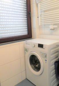 a washing machine in a bathroom with a window at Ferienwohnung Kurparkblick in Bad Windsheim