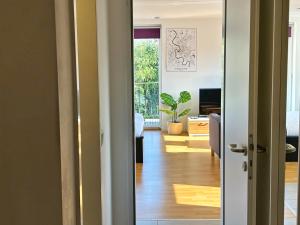 a hallway with a door open to a living room at Quiet Garden-View Studio Apartment in Düsseldorf