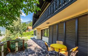 a patio with a table and chairs on a balcony at Pet Friendly Home In Obervellach With Kitchen in Obervellach