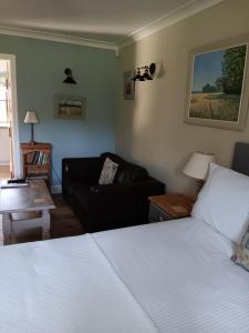 a living room with a bed and a couch at The Barn - Quiet Location in Ashford
