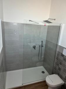 a bathroom with a shower and a toilet at Baglio Eldama in Castelvetrano Selinunte