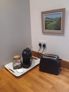 a counter with a toaster and a toaster on a table at The Barn - Quiet Location in Ashford