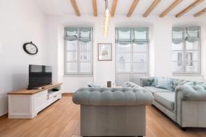 a living room with a couch and a tv at Premium Apartment Vergottini in Poreč