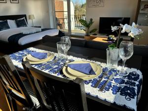 a dining room table with a blue and white table cloth at Quiet Garden-View Studio Apartment in Düsseldorf
