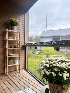 a balcony with a window with a basket of flowers at Ingas, Espoo- Whole apartment in Espoo