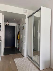 a hallway with a sliding glass door with a mirror at Ingas, Espoo- Whole apartment in Espoo