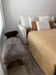 a bedroom with a bed and a couch and a rug at Ingas, Espoo- Whole apartment in Espoo