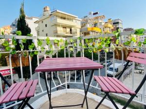 a picnic table and two chairs on a balcony at NESCLASS OTEL in Kusadası