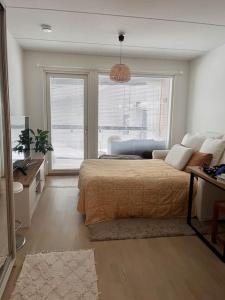 a bedroom with a bed and a large window at Ingas, Espoo- Whole apartment in Espoo