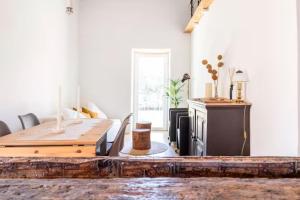 a living room with a wooden table and a couch at Casa da Figueira - Pool and Lounge in Praia do Ribatejo
