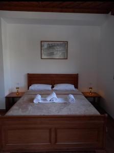 a bedroom with a bed with white towels on it at Castle Hotel in Gjirokastër