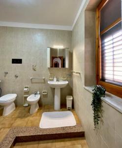 a bathroom with a sink and a toilet and a sink at Seaside Zerilli Apartment - XI Febbraio in Santa Flavia