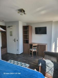 a living room with a couch and a table at Hotel Flots d'Azur in Nice