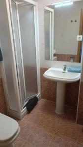 a bathroom with a sink and a shower and a toilet at HOSTAL CEPA DE ORO in Aranda de Duero