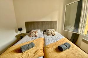 a bedroom with two beds with pillows on them at Les Naïades I46 - 2 bedrooms for 5 people ! in Avène