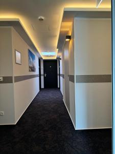 a hallway of an office building with a door and stripes at Skyline Hotel City Frankfurt in Frankfurt/Main