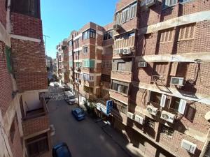 an aerial view of a street between two buildings at Light moon appartment in Luxor