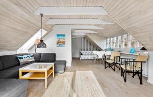 a living room with a couch and a table at 3 Bedroom Awesome Home In Skagen in Skagen