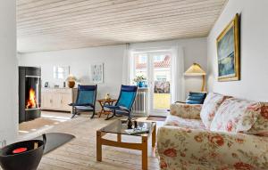 a living room with a couch and a fireplace at 3 Bedroom Awesome Home In Skagen in Skagen
