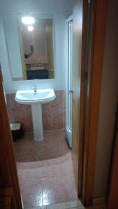 a bathroom with a white sink and a mirror at HOSTAL CEPA DE ORO in Aranda de Duero