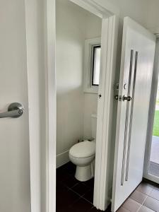 baño con aseo y ventana en Parkview Cottage en Henley Beach South