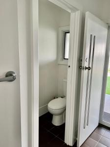 a bathroom with a toilet and a window at Parkview Cottage in Henley Beach South