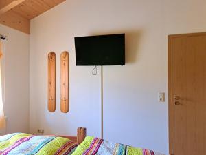 a bedroom with a bed and two skis on the wall at Ferienwohnung Sonnenschein in Nagel