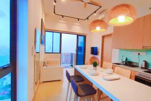 una cocina con encimera y algunas sillas. en CL24A 5-6pax KLCC Sky Pool Condo, en Kuala Lumpur