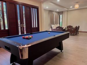 a pool table in a living room at Manee Poolvilla in Khanom