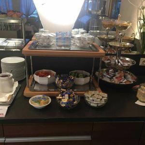 a buffet with many plates and bowls of food at Kurhotel Pyramide AG in Bad Windsheim