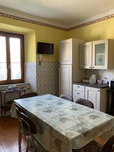 a kitchen with a table and a kitchen with a table and chairs at B&B da Paola in Bardalone