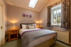 a bedroom with a bed and a window at Elterwater Park self catering in Ambleside