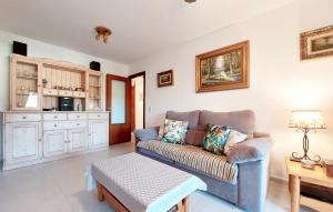 a living room with a couch and a table at 2 Bedroom Nice Apartment In Benicàssim in Benicàssim