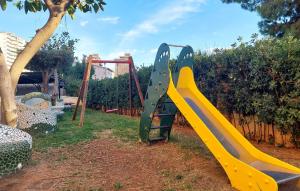 a playground with a slide in a yard at 2 Bedroom Nice Apartment In Benicàssim in Benicàssim