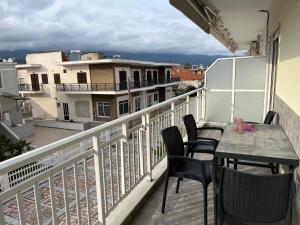 a balcony with a table and chairs on a balcony at House Kohili in Nea Vrasna